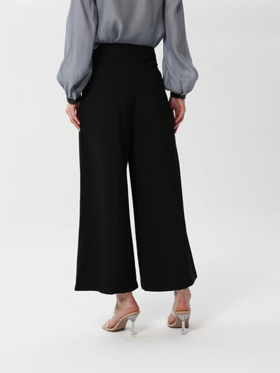 Formal trousers with a wide waist and buttons on the front