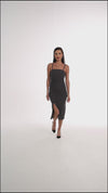 Midi dress with ruffles at the waist, a thigh slit, and half straps with metal decoration